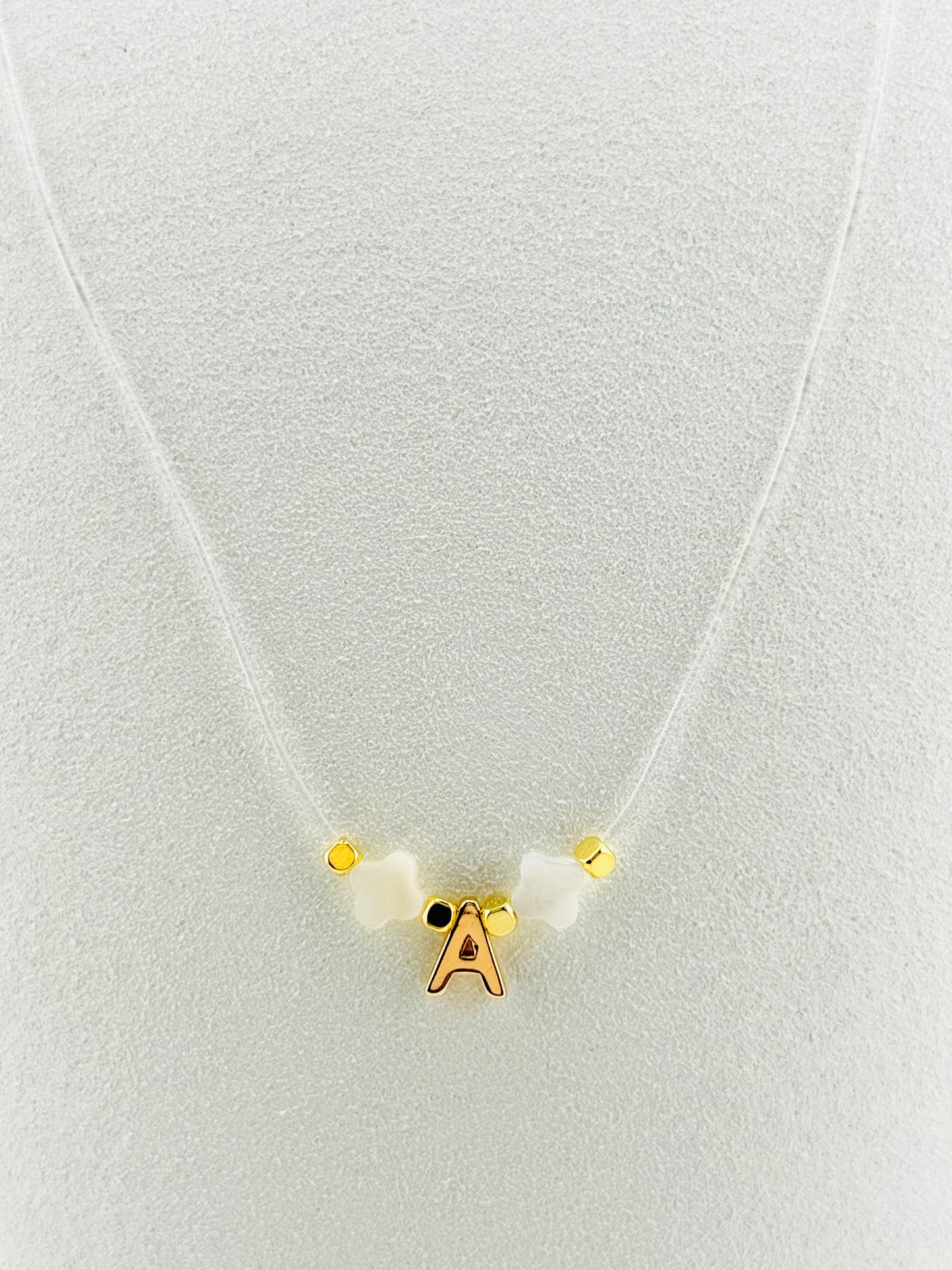 Gold filled initial with mother of pearl transparent string