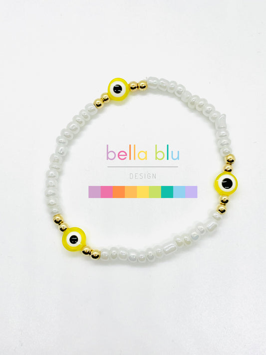 white and yellow evil eye bracelet