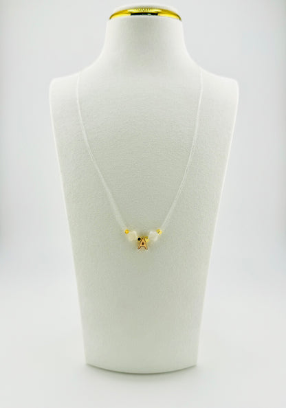 Gold filled initial with mother of pearl transparent string