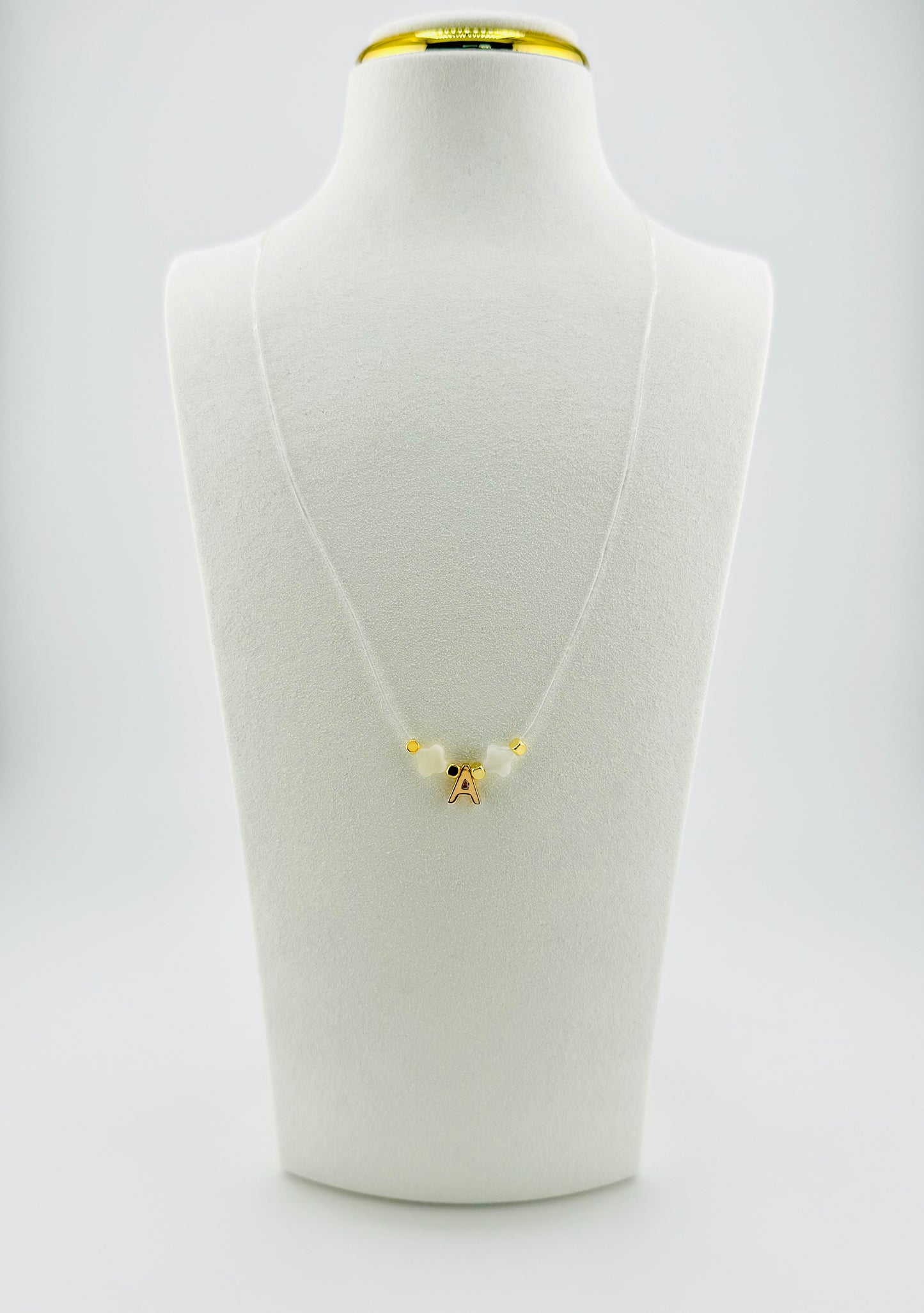 Gold filled initial with mother of pearl transparent string